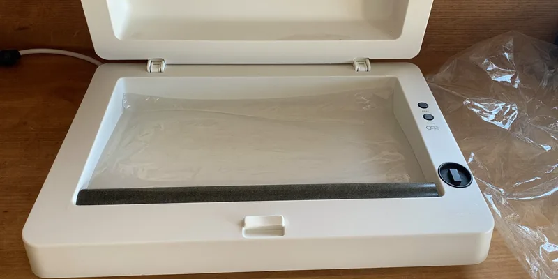 Opened white vacuum sealer showing its foam gasket strip