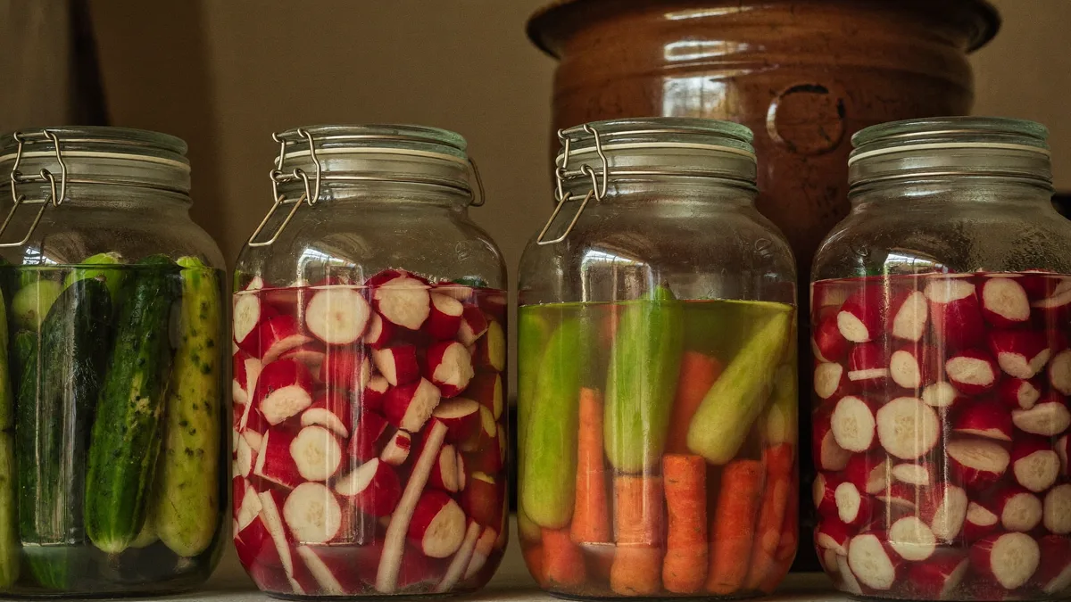 Fermentation jars with cabbage under glass weights