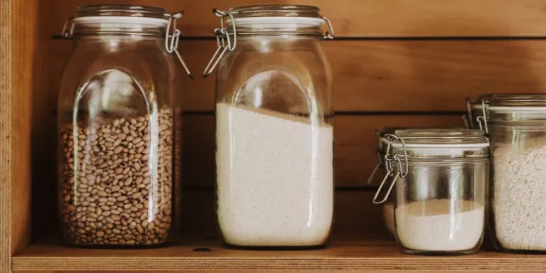 Large half gallon jars filled with beans and rice on a pantry shelf