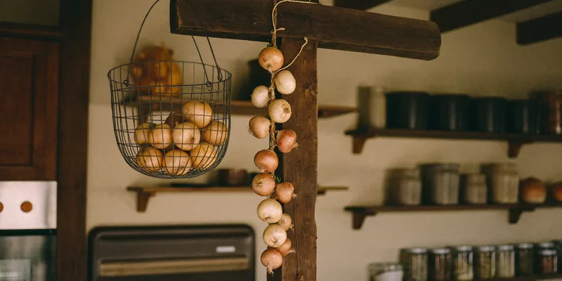 Wire basket of onions and a hanging onion braid