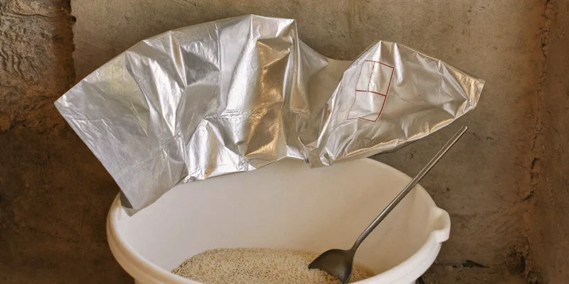 Open mylar bag inside a bucket half filled with rice