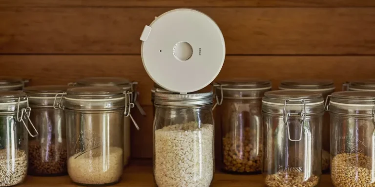 Round white vacuum sealing unit on top of a jar of rice