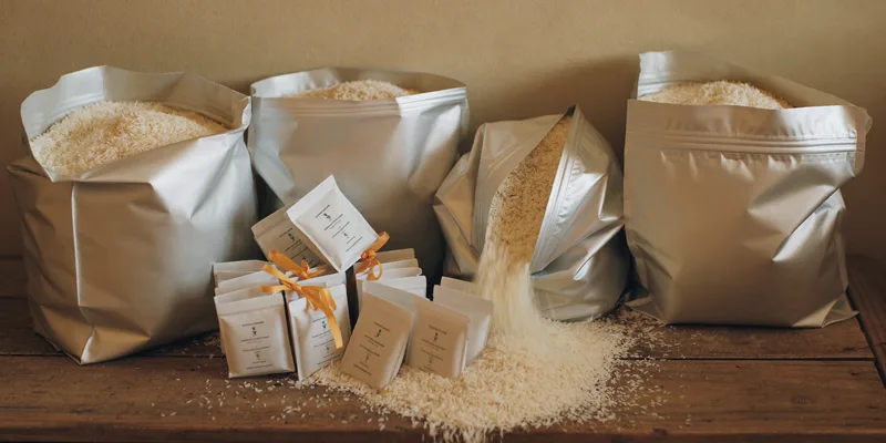 Opened silver mylar bags of rice with sachet packets