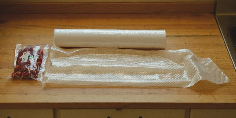 Roll of clear vacuum bag material with a sealed bag of berries