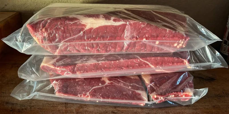 Cuts of beef tightly vacuum sealed in clear plastic