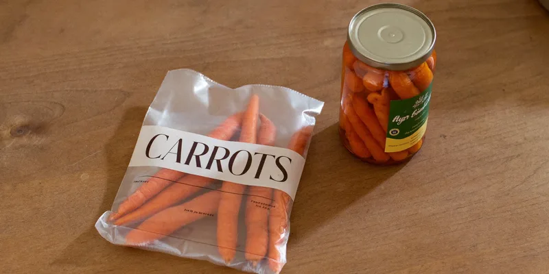 Bag of carrots beside a jar of carrots preserved two ways
